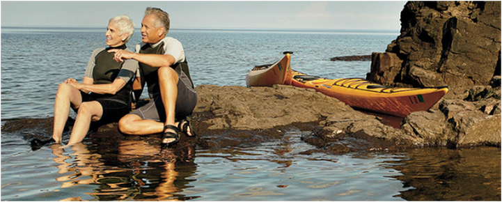 Older Couple on a rock in the ocean.