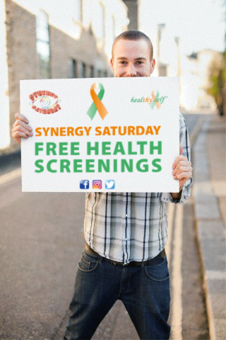 man holding synergy saturday sign.